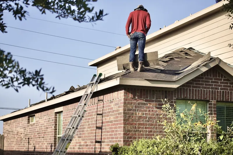 Professional roofer working on a residential roof in Highland Acres